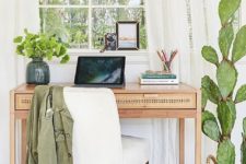 greenery in a vase and a large cactus in a pot refresh the space and make it more bright and welcoming