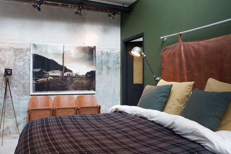 industrial bedroom with a cool headboard and a green wall