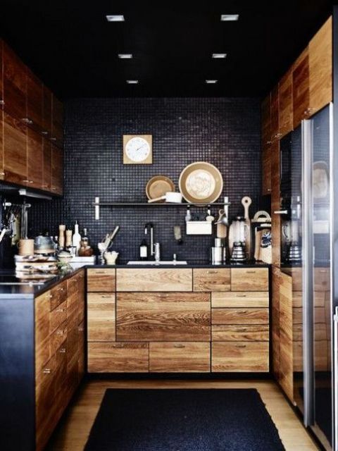 light-colored wooden cabinets with black metal countertops and blakc tile backsplashes for a contrasting look