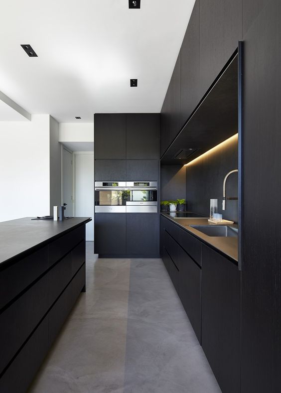 matte sleek kitchen cabinets, built-in lights, stone countertops and built-in appliances for elegant chic