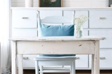 some flowers in a jar and blooming cheery branches plus a floral artwork make the space more spring-like