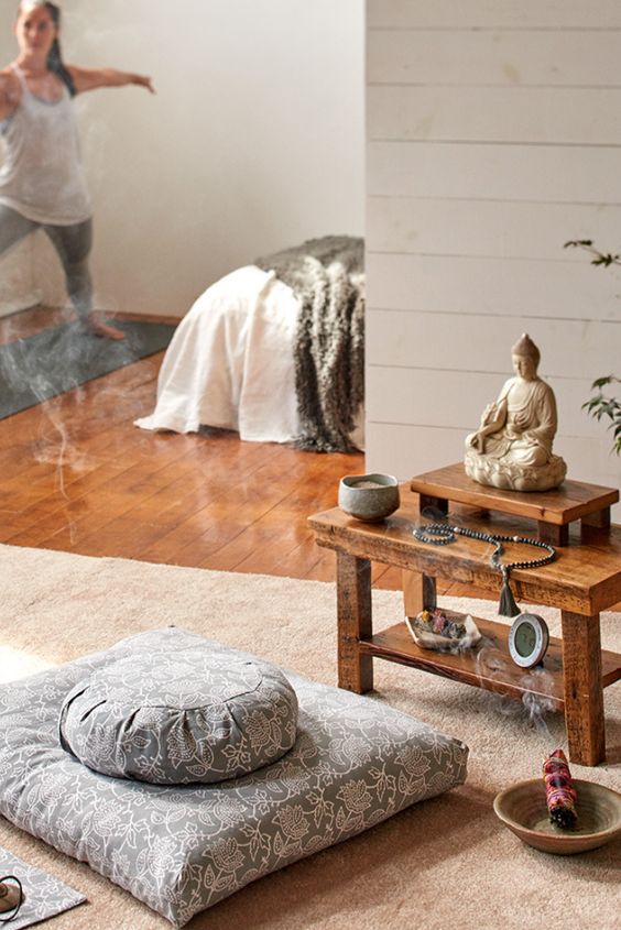 a boho-inspired meditation space with cushions and pillows and shelves with lots of Eastern stuff