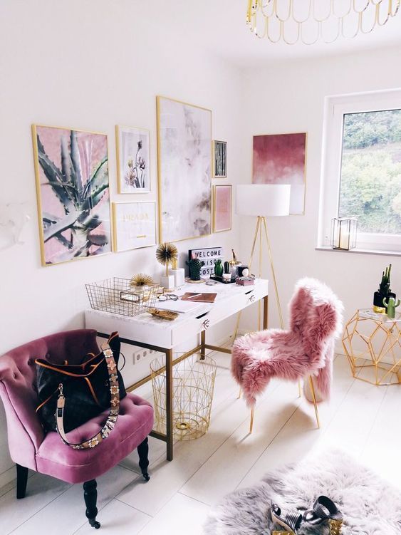 a bright and chic girlish home office with a pink fur chair, a purple chair and a pink and purple gallery wall