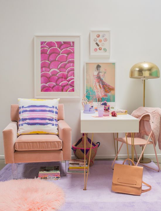 a colorful feminine space with a bright gallery wall, blush chairs and a rug and touches of gold for more chic
