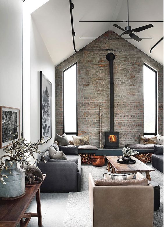 a cute living room design with a stone accent wall