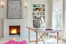 a glam home office with a fireplace, a desk, a hot pink rug and some comfy furniture