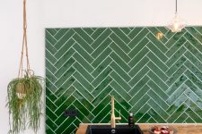 a graphite grey kitchen, butcherblock countertops and a bold green chevron tile backsplash for a lovely and bright look