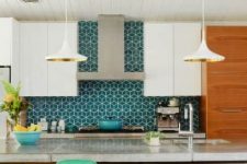a light-stained and white kitchen with sleek cabinets and a bold blue geo tile backsplash that adds interest and color to the space