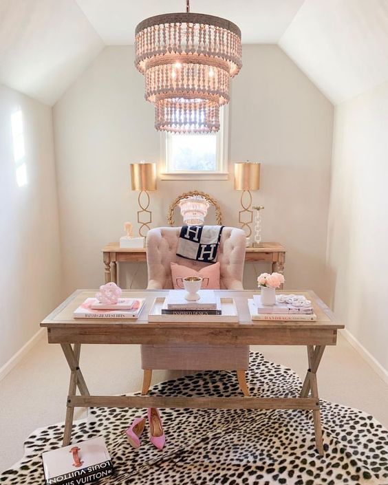 https://www.digsdigs.com/photos/2013/04/a-refined-feminine-home-office-with-wooden-furniture-pink-pillows-a-printed-rug-and-a-statement-chandelier.jpg