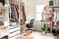 a stylish cloffice with open storage units, drawers and an open storage rack, a pink pouf, a white desk and a crystal chandelier