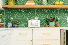 a white shaker kitchen with white stone countertops and a bold green geo print backsplash, open shelves and potted blooms and plants
