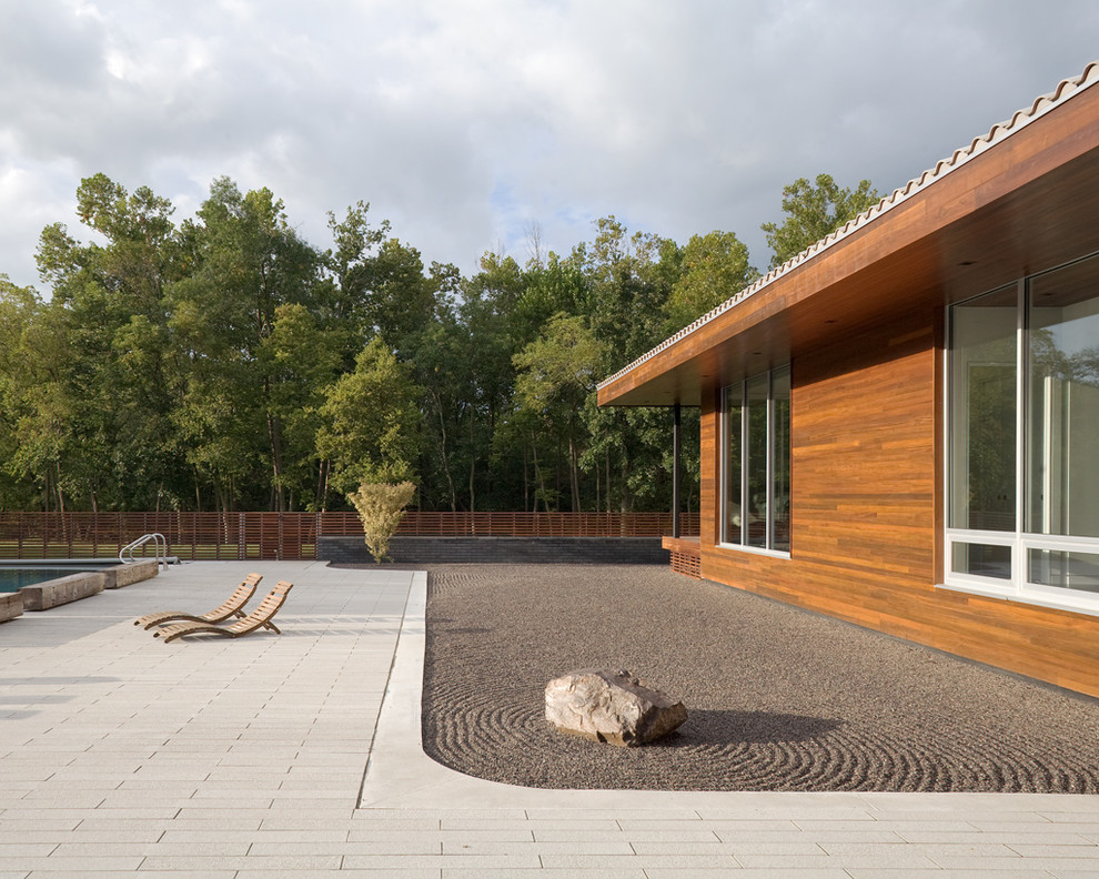 Minimalism is the main characteristic you should consider designing a Zen garden. A single rock on a rippled sand area is enough.