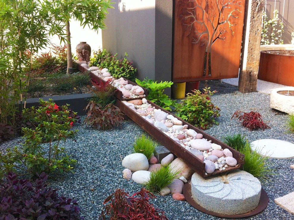 A dry river bed and a faux waterfall is a great combo for dry landscaping.