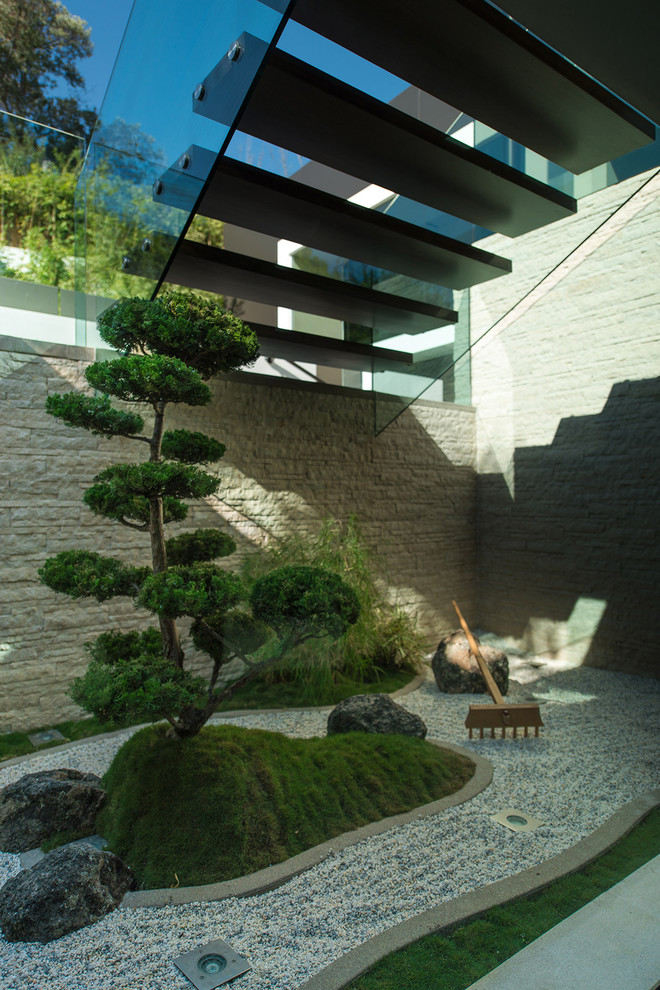 Cloud-pruned conifers could be found in many Asian-inspired gardens because of their elegant looks. A conifer on a mossy green base surrounded by several rocks would definitely mimic some mountain's landscape.