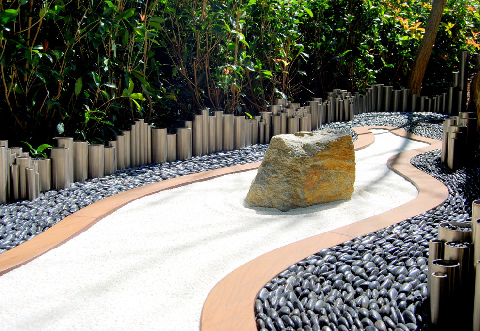 If you have kids you can design a sandpit for them that would look like a small zen-garden if you rake the sand over after their play session.