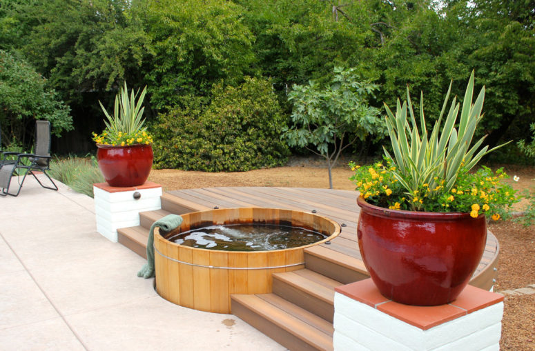 Large planters by the tub is a great way to decorate the surrounding area. (Michael Glassman &amp; Associates)