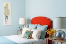 a light blue bedroom with a red touch