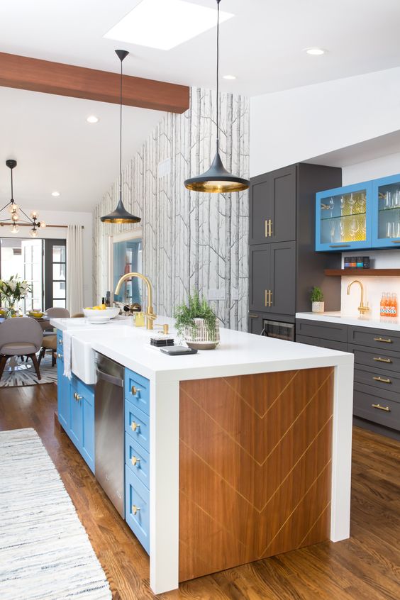 a bright blue and plywood kitchen island with a white countertop plus drawers for storage and appliances