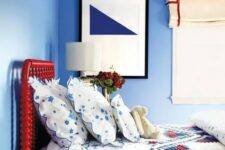 a bright red bed is a statement in a blue bedroom and an interesting color touch