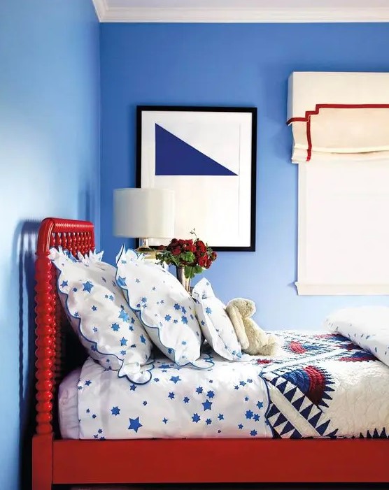 a bright red bed is a statement in a blue bedroom and an interesting color touch