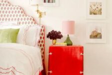 a bright red nightstand and a red floral print upholstered bed for a cute touch