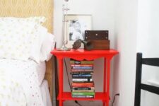 a bright red nightstand matches the bedroom style but adds a touch of super bold color