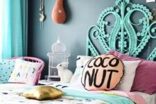 a colorful bedroom with a black accent wall, a hot pink chair, a turquoise bed, bright printed bedding, a flamingo head on the wall