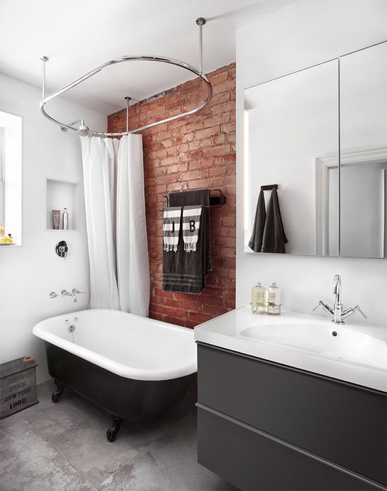 a contemporary bathroom with a red brick touch that makes it more industrial and more eye-catchy