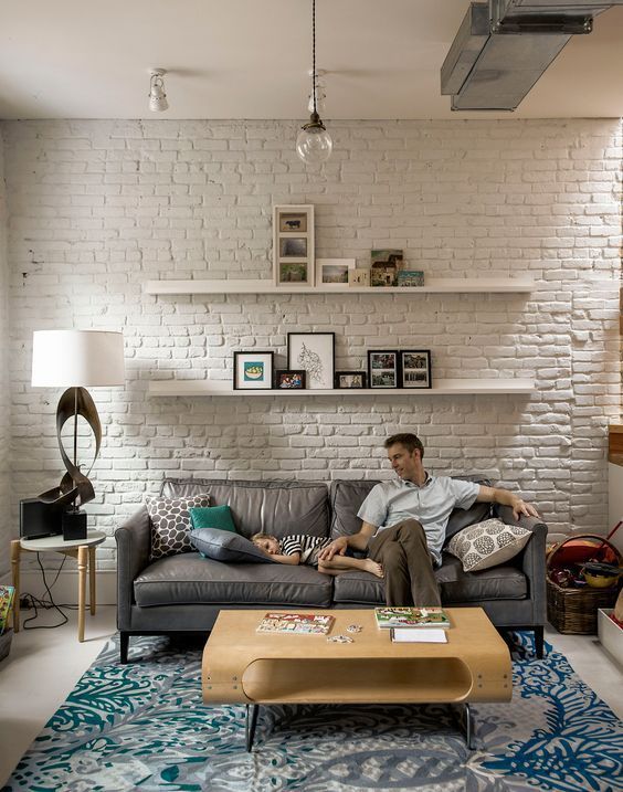 a contemporary living room refreshed with textiles and a white brick statement wall