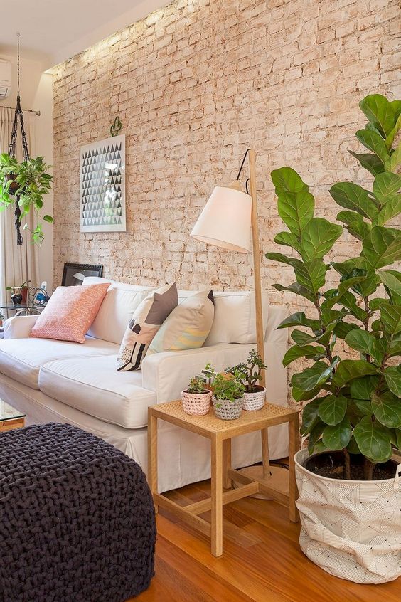 a cozy living room with a muted brick wall that is textural yet rather soft-looking