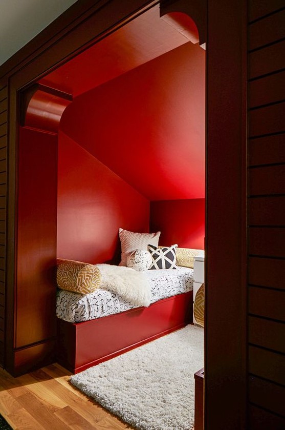 a double guest bedroom with red walls, red beds and printed bedding looks cool and very cozy