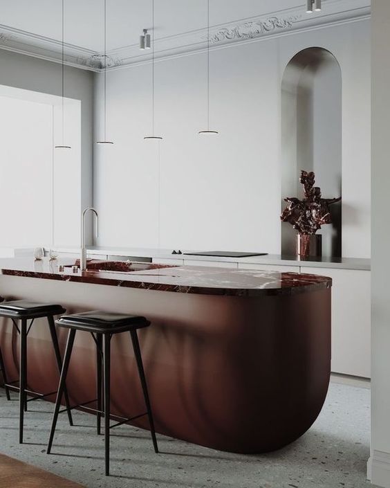 a gorgeous metal and stone kitchen island in rich rust tones is a fantastic statement with both color and shape for a neutral kitchen