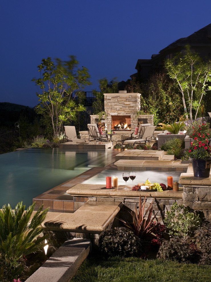a hot tub combined with a fireplace would make any outdoor place trully awesome