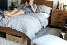 a neutral rustic and vintage bedroom with a faux brick wall, rich stained furniture and jute ottomans looks awesome