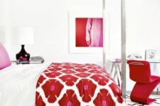 a pure white bedroom spruced up with color, with a canopy bed with colorful bedding, a glass desk, a red chair, a bold artwork