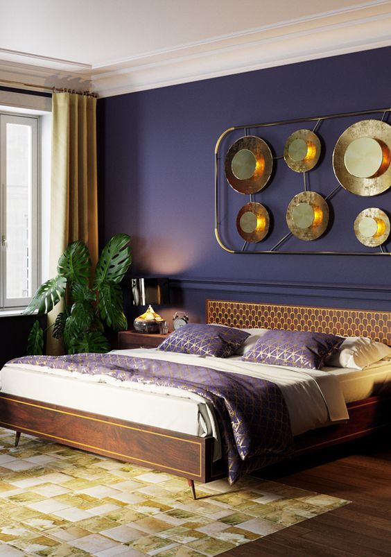 a refined tropical bedroom with a deep purple wall, dark stained furniture, an arrangement with metallic plates, a potted plant