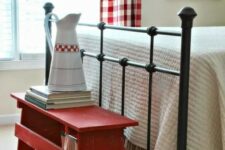 a simple red bench at the footrest is a creative idea for storage and adding a farmhouse feel