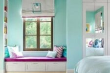 a turquoise bedroom with a window reading nook with built-in shelves, a bed with turquoise and white bedding and silver poufs
