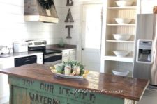 a vintage industrial kitchen island of wood with a green base of crates that looks very eye-catchy