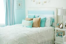a vintage-inspired bedroom with a turquoise accent wall, a bed with a striped headboard, pastel bedding, striped curtains