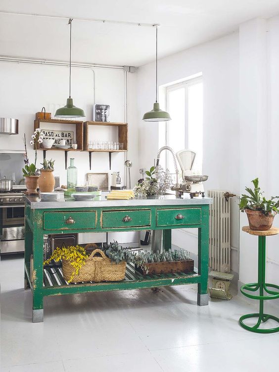 a vintage kitchen with open shelves instead of cabinets, stainless steel appliances, a green kitchen island of wood