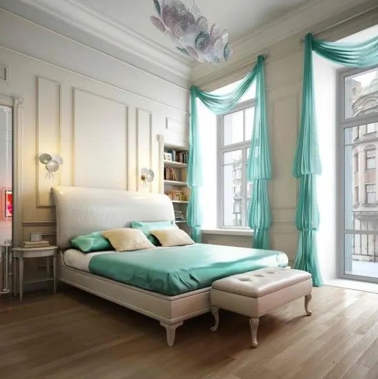 a vintage neutral bedroom with high ceilings, large windows with turquoise curtains and turquoise bedding to add more color and life to the room