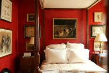 a vintgae-inspired bold red bedroom with a refined cnaopy bed, vintage artworks, nightstands and table lamps and a bench with books