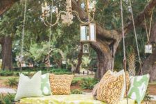 an outdoor hanging bed for one, some lanterns and ropes for decor and printed pillows is a bright idea