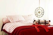 deep red and pink and white striped bedding set spruces up a neutral bedroom and raises the mood