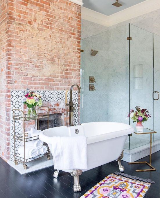 red brick highlights the fireplace and makes the bathroom look very vintage-like and very refined
