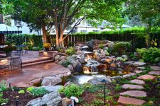 stone pavers is the best way to cover the area around stone waterfall