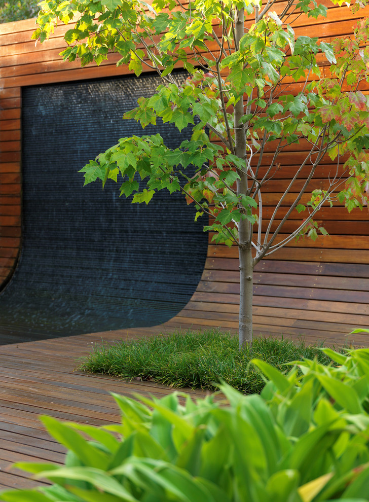 A curved bluestone water wall would definitely become a focal point of any backyard.