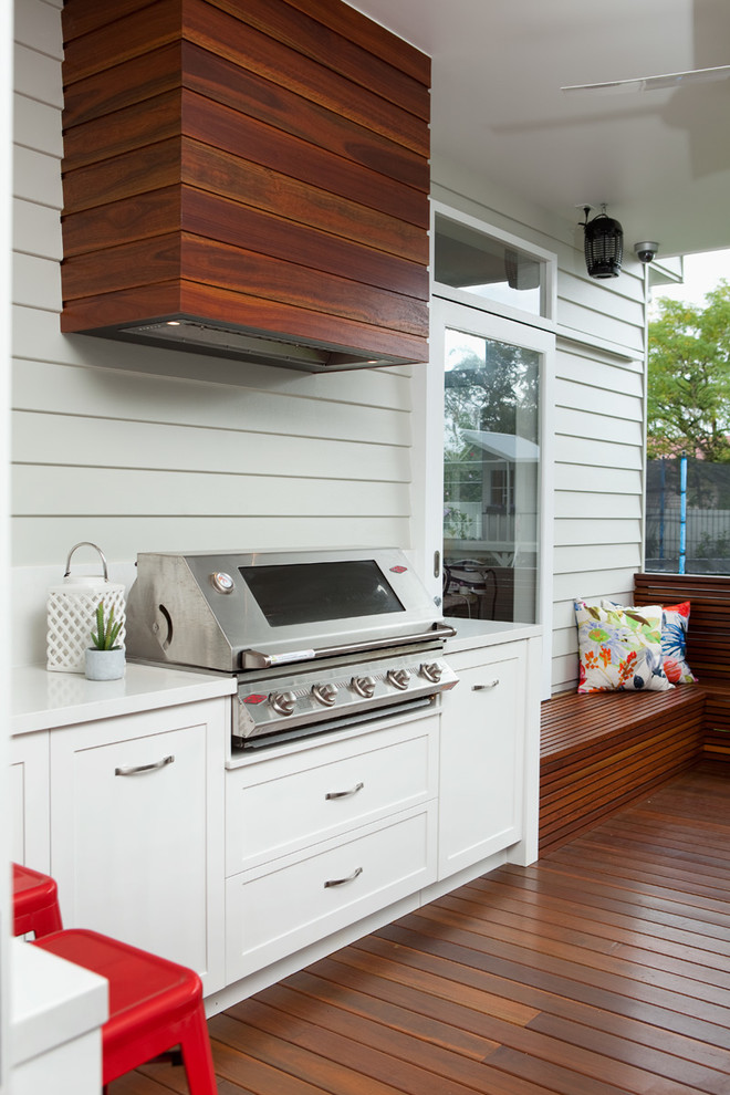 Covering a cooking hood with wood planks could help to blend it with a deck.