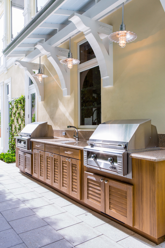 Placing kitchen cabinets right to house's walls would eliminate a need to build a separate roof.